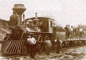 This view captures the unfinished quality of many antebellum railroads. The crew in the foreground is almost certainly American-born; the men on the flat cars are almost certainly immigrants making a dollar or two for a twelve-hour day.