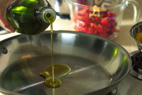 Pouring olive oil into pan