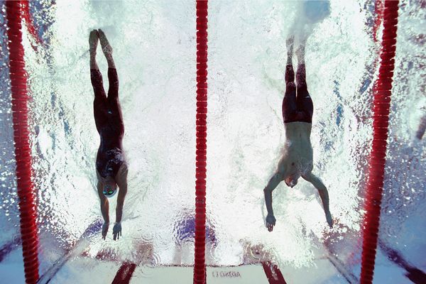 Milorad Cavic (L) and Michael Phelps (R) both reach for the wall during the men’s 100-meter butterfly final at 2008 Beijing Summer Olympics