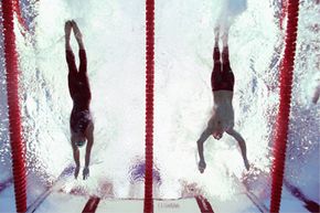 Milorad Cavic (L) and Michael Phelps (R) both reach for the wall during the men’s 100-meter butterfly final at 2008 Beijing Summer Olympics