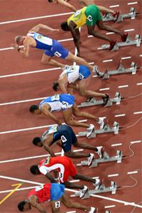 Competitors start the second heat of the men's 110-meter hurdles at the 2008 Beijing Olympics. The competitor wearing number 7 appears to have jumped the gun.