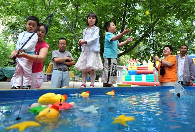 Families celebrate Children's Day at a park in Beijing.