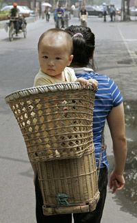 A mother caries her baby in Beijing.