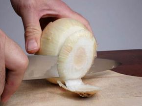 Slicing open an onion releases enzymes that irritate the eye.