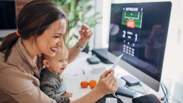 A woman carrying baby participating on online gambling