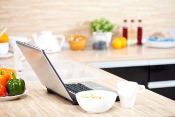 Laptop in kitchen. 