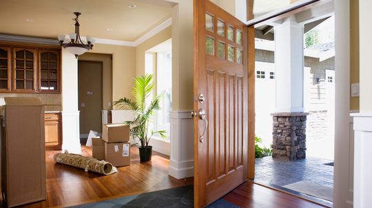 Why do the entry doors to most homes open inward, while in most public buildings, the entry doors open outward?