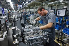 Workers assemble engines for Porsche 911 cars at the Porsche plant in Zuffenhausen, Germany. A complex task, no doubt. Ecomotors estimates that the number of moving parts in its engine has been reduced from 385 to 62, making it much easier to service.