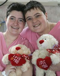 Sisters Carol and Tracey Playfair recover together after surgery. Tracey donated a kidney to save Carol's life.