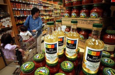 A shopper in Tustin, California walks by certified organic products at Whole Foods Market 