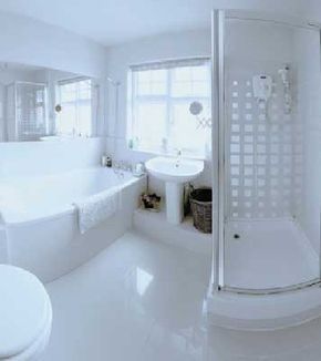 A cozy bathroom that uses windows and mirrors to brighten up the space.&nbsp;