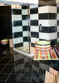 A bathroom designed with checkers and funky colors giving it a unique personality.&nbsp;
