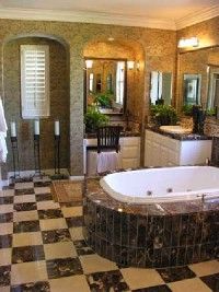 A spacious bathroom with a separate vanity table and a large soaker tub.&nbsp;