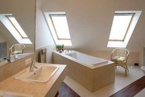 A neutral bathroom highlighted by a uniquely designed, rectangular soaker tub.&nbsp;