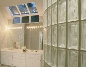 A spa-like bathroom featuring glass accents and a white and off-white palette.&nbsp;