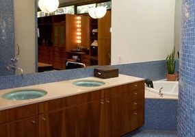 A functional bathroom featuring a large mirror and two separate sinks.&nbsp;