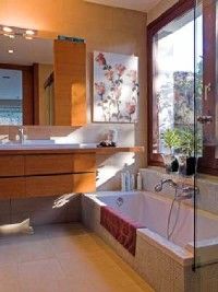 A modern bathroom featuring a large window that's flooding the room with natural light.&nbsp;