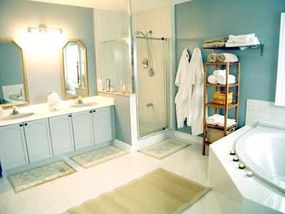 A bathroom that uses bright shades of blue and green to lighten up the space.&nbsp;