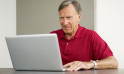 Retiree at computer