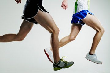 two male runners in mid-stride, low section