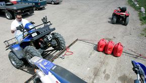 man drives atv onto trailer