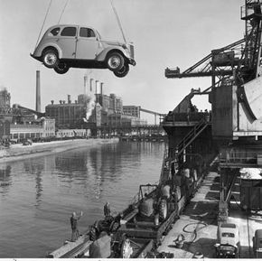 A car is loaded onto an English ship for export. This type of auto transport works well for foreign and exotic cars.