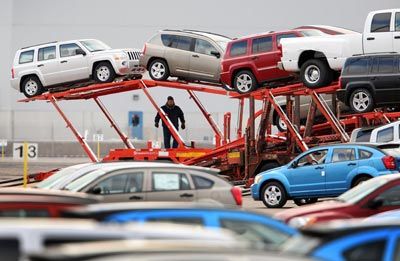 Workers load Chrysler vehicles for transport in Illinois.