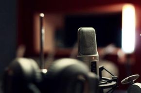 Microphone in studio with headphones in foreground