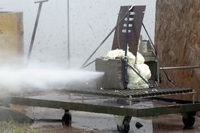 A stream of water blasts through a compilation of steel, concrete block and polystyrene foam during a demonstration at the University of Missouri-Rolla's High Pressure Waterjet Laboratory in Rolla, Mo.