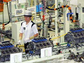 An employee works on the production line at Toyota Motor Corp in Japan.