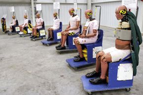 Crash test dummies sit on display at General Motors' new $10 million crash testing center in Milford, Mich. GM announced that rollover air bags will be standard equipment in all its vehicles by 2012.