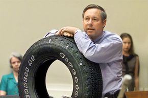 Rep. Fred Upton, R-Mich., displays a Firestone Wilderness AT model tire during a House Commerce Committee hearing on Capitol Hill, on June 19, 2001, looking into Ford Motor Company's recall of Firestone tires.