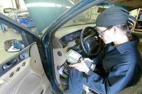 In her Automotive Technology class at Wenatchee Valley College in Wenatchee, Wash., Amber Horn uses a scan tool to check over various systems in a 1995 Ford Windstar on April 14, 2004.