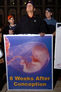 An anti-abortion protestor showing the development of a fetus at 8 weeks.