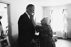 An elderly woman thanks President Lyndon B. Johnson for his signing of the Medicare health care bill in April 1965.