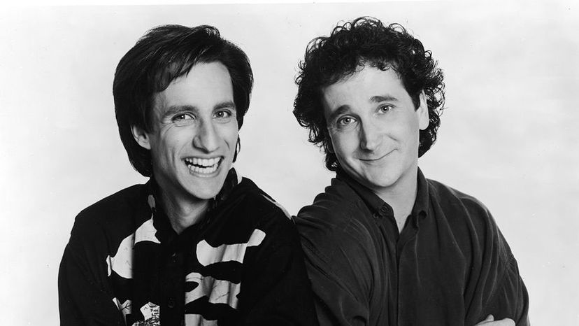 Bronson Pinchot (L) and Mark Linn-Baker lean against one another in a promotional portrait for the television series, 'Perfect Strangers.' Pinchot played a naïve shepherd with an unplaceable accent. Lorimar Television/Fotos International/Courtesy of Getty Images