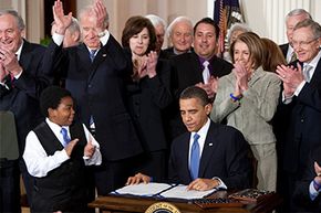 President Obama signs the Affordable Care Act.