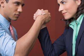 man and woman arm wrestling