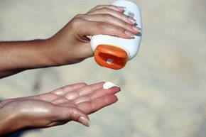 close up of hand receiving sunblock cream lotion