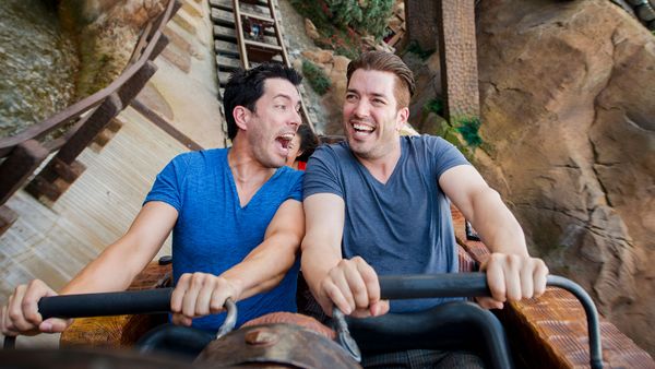 Two men smiling outdoors.