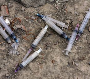 Used needles litter the ground outside an abandoned buildingwhere many addicts live in Kabul, Afghanistan.