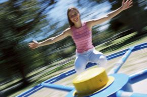 Woman on playground merry-go-round
