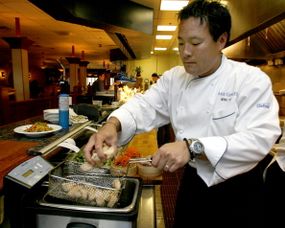 ming tsai cooking food in a fryer