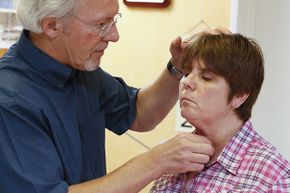 A doctor checks a woman's thyroid gland. Hypothyroidism can cause you to gain weight.