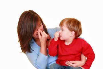 Woman and boy holding noses