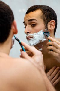 morning routine: a man shaving before going to work