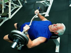 older man lifting weights