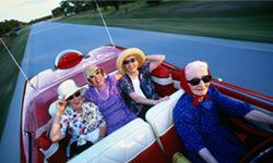 Four old women in a bright red convertible.