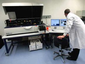 A researcher operates an LSR II, an advanced sample analyzing machine, at the opening of the Internaional AIDS Vaccine Initiative's new laboratory in New York City.