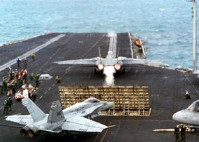 An F-14 Tomcat, positioned in front of the jet blast deflector on USS Nimitz's catapult number 1